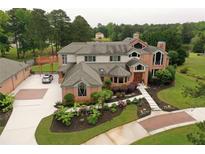 Stunning aerial view showcasing the estate's expansive grounds, lush gardens, and circular driveway at 794 Rutland Ct, Lithonia, GA 30058