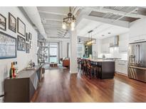 Bright open-concept living room and kitchen featuring hardwood floors and modern decor at 805 Peachtree Ne St # 411, Atlanta, GA 30308