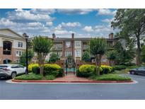 Beautiful brick condo building with meticulously maintained landscaping, a secure gate, and private balconies at 825 Highland Lane Northeast Ne # 1313, Atlanta, GA 30306