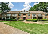 Charming brick building with balconies and manicured landscaping offers inviting curb appeal at 3650 Ashford Dunwoody Ne Rd # 514, Atlanta, GA 30319