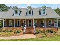 Charming brick home with a welcoming front porch and well-maintained landscaping at 705 S Bethany Rd, Mcdonough, GA 30252