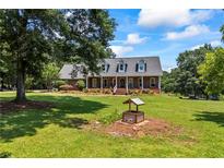 Spacious two-story brick home featuring mature trees, a well and a beautifully landscaped front yard at 705 S Bethany Rd, Mcdonough, GA 30252