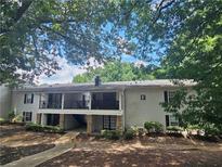 Charming two-story condo featuring stone accents, covered balconies and lush landscaping at 1150 Collier Nw Rd # 12F, Atlanta, GA 30318
