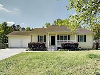Charming single-story home featuring a well-maintained front yard and an attached two-car garage at 365 Wesley Mill Pl, Villa Rica, GA 30180