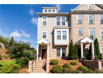 Charming townhome featuring a brick facade, well-maintained landscaping, and an inviting front entrance at 621 Hanlon Way, Alpharetta, GA 30009
