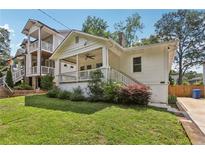 Charming exterior of a white house with a cozy front porch and well-manicured lawn at 1633 Woodbine Ne Ave, Atlanta, GA 30317