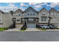 Charming townhome exteriors feature varied colors, stone accents, garages, and landscaped entryways at 2719 Hedgeway Cir, Kennesaw, GA 30144
