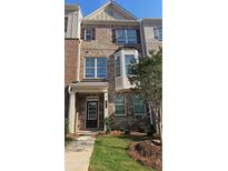 Charming brick townhome with a well-maintained lawn and a welcoming front entrance at 543 Fundao Ln # 26, Lawrenceville, GA 30046