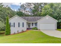 Charming single-Gathering home with a well-maintained lawn and attached garage at 1900 Tribble Ridge Dr, Lawrenceville, GA 30045