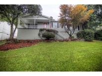 Charming single-Gathering home with a cozy front porch and a beautifully landscaped yard at 2002 Shalimar Ne Dr, Atlanta, GA 30345