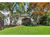 Charming home with a covered front porch and a beautifully landscaped front yard and vibrant foliage at 2002 Shalimar Ne Dr, Chamblee, GA 30345