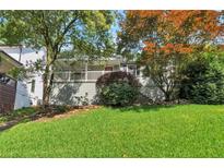 Charming home with inviting front porch, manicured lawn, and mature landscaping at 2002 Shalimar Ne Dr, Chamblee, GA 30345