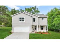 Charming two-story home with attached garage and well-maintained front yard at 156 Club Cir, Stockbridge, GA 30281