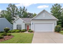 Charming home featuring manicured landscaping, a two-car garage, and inviting curb appeal at 4322 Braden Nw Ln, Kennesaw, GA 30144