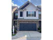 Charming townhome with a two-car garage and a beautifully designed facade with stone accents at 5715 Radford Loop # 15, Fairburn, GA 30213