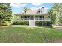 Charming home with a welcoming front porch and well-maintained lawn at 98 Little John Way, Douglasville, GA 30134