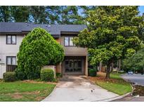 Charming townhome with mature trees, neutral siding, and driveway, offering a welcoming curb appeal at 2471 Cedar W Brk, Marietta, GA 30067