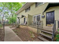 Two-story building with olive green brick and a small porch with stairs leading to the entrance at 411 10Th Ne St # 6, Atlanta, GA 30309
