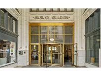 Elegant building entrance with a gold revolving door and the words 'Healey Building' above at 57 Forsyth Nw St # 16G, Atlanta, GA 30303