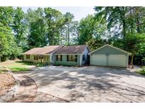 Charming home featuring a spacious driveway, attached two-car garage, and a beautiful, wooded lot at 2639 Hummingbird Nw Dr, Duluth, GA 30096