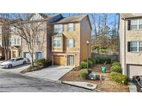 Charming two-story townhome with neutral siding, attached garage, and well-manicured landscaping at 2793 Keystone Ave, Lithonia, GA 30058