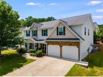 Charming two-story home with a two-car garage and manicured lawn in a residential neighborhood at 105 Lanier Xing, Hiram, GA 30141