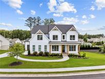 Beautiful two-story white home with a landscaped yard, complemented by a charming walkway to the front door at 6080 Simone St, Acworth, GA 30101