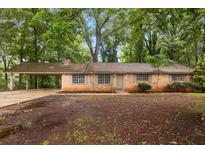 Charming single-story brick home featuring a covered carport and a cozy, inviting curb appeal at 1513 Dupree Rd, Woodstock, GA 30189