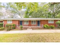 Charming brick duplex featuring covered entryways and well-maintained landscaping at 5952 Medlock Ave, Austell, GA 30106