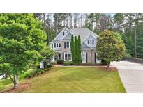 Beautiful two-story home featuring a well-manicured lawn and a mix of brick and siding at 212 Thorncliff Way Way, Acworth, GA 30101