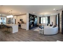 Open-concept living room features modern decor, wood floors, and an elegant black media center at 371 Grant Cir # 1812, Atlanta, GA 30315