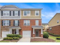 Charming townhome with brick and siding, featuring a well-maintained lawn and attached garage at 801 Tulip Poplar Way # 2501, Lawrenceville, GA 30044