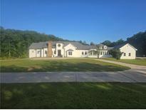 Beautiful, spacious white home with a large front yard and a winding driveway at 1169 Hodges Cir, Mansfield, GA 30055