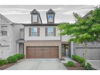 Charming two-story townhouse with a two-car garage and manicured landscaping, providing great curb appeal at 3246 Spicy Cedar Ln, Lithonia, GA 30038