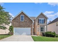Charming two-story home featuring a stone facade, attached garage, and well-maintained lawn on a sunny day at 915 Pebble Creek Trl, Suwanee, GA 30024