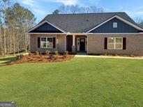 Inviting single-story home with a lush green lawn, brick facade, and well-maintained landscaping at 3402 Milan Ct # 1 Plapprox Sqft 2, Douglasville, GA 30135