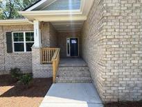 Brick house featuring a covered front entrance and large window at 3402 Milan Ct, Douglasville, GA 30135