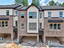 Modern townhome with brick facade, attached garages, and neutral-toned siding at 6 Rock Park Way # 15, Tucker, GA 30084
