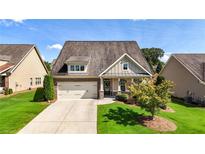 Charming single-Gathering home with a well-manicured lawn and two-car garage at 5640 Hammock Way, Cumming, GA 30028