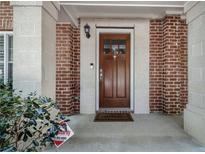 Charming brick-accented entryway with a wood front door and welcoming welcome mat at 1836 Preserve Way, Brookhaven, GA 30341