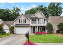 Charming two-story home with a front porch and a well-manicured lawn with a flower bed at 306 Overbend Sw Lndg, Marietta, GA 30008