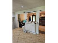 Inviting living room features tile floors, columns, and access to backyard at 616 Burnt Creek Nw Way, Lilburn, GA 30047