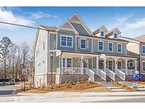 Charming two-story home with covered porch, landscaped yard and blue and grey siding at 164 Palm St, Holly Springs, GA 30188