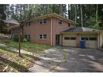 This house has a brick exterior, attached garage, and a basketball hoop near the driveway at 3798 King Henry Sw Rd, Atlanta, GA 30331