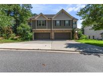 Charming townhome with two-car garage and craftsman-style architecture in a well-manicured community at 4746 Highland Ave, Sugar Hill, GA 30518