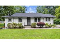 Charming single-story home with a well-maintained lawn and tidy landscaping at 5599 Redan Cir, Stone Mountain, GA 30088