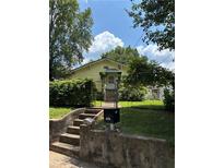 Charming single-story home with mature trees and front yard fenced-in with black iron at 661 Federal Se Ter, Atlanta, GA 30315