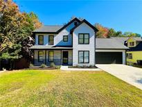 Charming two-story home with landscaped lawn, covered porch, and a two car attached garage at 430 Thornbush Trce, Lawrenceville, GA 30046