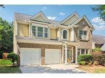 Charming two-story home with a brick and siding facade, featuring an attached two-car garage at 1755 Rutland Pass Dr, Lawrenceville, GA 30045