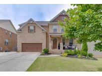 Beautiful two-story brick home with a well-manicured lawn and a two-car garage in a desirable neighborhood at 1830 Secretariat Gait Way, Suwanee, GA 30024